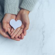 paper-heart-put-couple-s-hands-marble-table